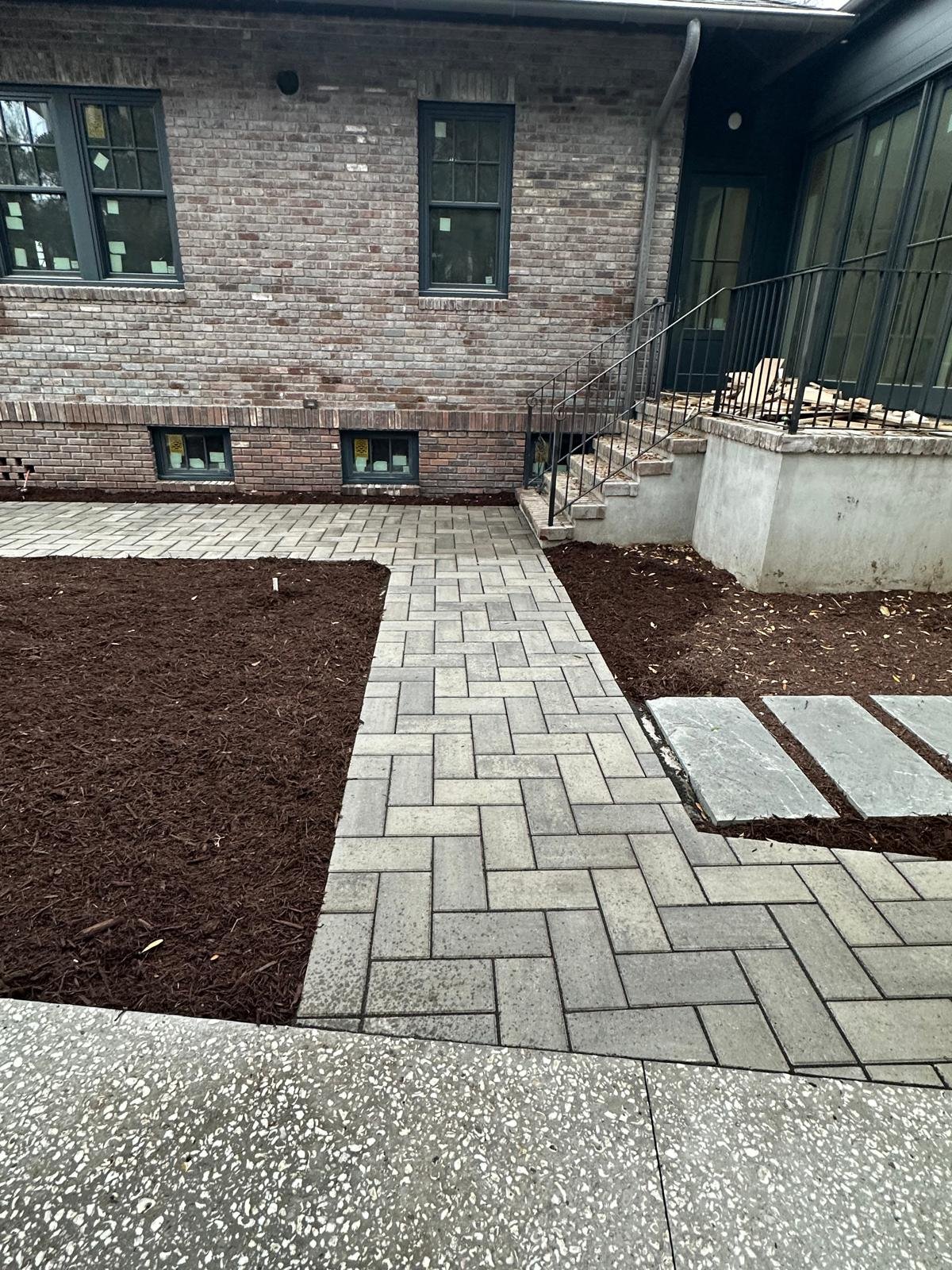 Custom stone masonry wall and landscape planting